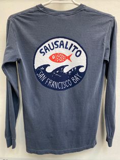 That moment a fish leaves the briny San Francisco Bay and finds itself momentarily airborne above the waves.100% cotton garment dyed long sleeve shirt will shrink no further with washing. Large back print and right hand breast small print. Shirt made by Comfort Colors. Long Sleeve Washed Cotton T-shirt, Washed Cotton Long Sleeve T-shirt, Blue Soft-washed Long Sleeve T-shirt, Long Sleeve Washed T-shirt Relaxed Fit, Long Sleeve Washed Relaxed Fit T-shirt, Cotton Tops With Back Print For Surfing, Soft-washed Long Sleeve Shirt With Relaxed Fit, Long Sleeve Washed T-shirt For Fall, Long Sleeve Cotton T-shirt For Surfing