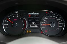 the dashboard of a car with speedometers and gauges