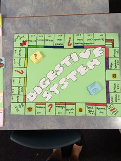 a board game sitting on top of a table with pieces of paper and magnets