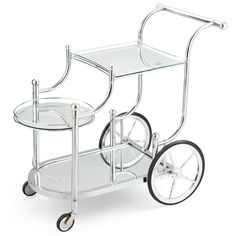 a glass and metal serving cart with wheels on the bottom shelf is shown in front of a white background