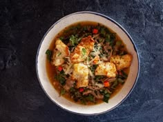 a white bowl filled with soup on top of a table