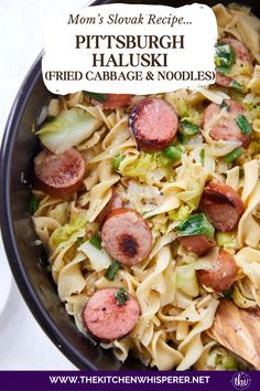 a bowl filled with pasta and sausage on top of a table