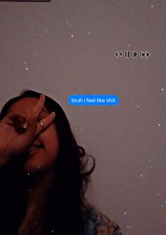 a woman holding her hand up to her eye while looking at the stars in the sky