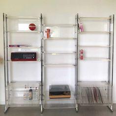 three shelves with various items on them in a room