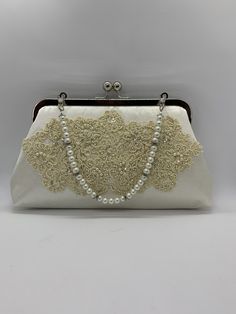 This gorgeous clutch purse was custom made using an old wedding dress that the customer provided  with Glass pearl handle  #fashion #wedding #clutch #zbesties #custommade #bridal #purses #bride2019 #jemdesign567 Elegant Beige Bag For Vintage Events, Vintage Beige Evening Bag For Wedding, Vintage Cream Bag For Wedding, Vintage Cream Bags For Weddings, Vintage Cream Evening Bag For Wedding, Vintage Beige Clutch For Wedding, Vintage Beige Wedding Clutch, Elegant White Evening Bag For Vintage Events, Elegant Cream Bag For Ceremony