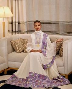 This beautiful Habesha dress is a true masterpiece, combining traditional elegance with modern simplicity. The soft and luxurious Menen fabric adds a touch of sophistication, while the intricate Tilf design creates a beautiful visual texture that is both unique and eye-catching. The dress features a Shimena accent, which adds a touch of regality to the overall design. The dress is tailored to perfection, hugging your curves in all the right places while still allowing you to move with ease. The White Handloom Straight Kurta, Elegant White Kaftan For Transitional Season, Elegant Handloom Straight Kurta, Elegant Handloom Wedding Dresses, Elegant White Straight Kurta Kaftan, Ceremonial White Saree Dress, White Ceremonial Saree Dress, Handloom Long Sleeve Wedding Dress, Festive White Dress With Weaving Work