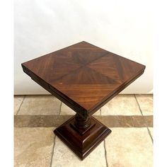 a wooden table sitting on top of a tiled floor