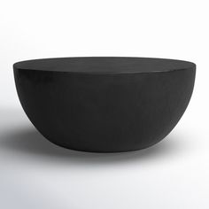 a black bowl sitting on top of a white table