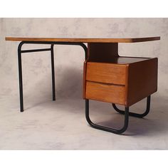 a wooden desk with two drawers on each side and a metal frame around the top