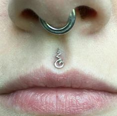 a close up of a person's nose with a ring on it