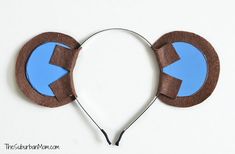 a pair of headphones made out of cardboard with blue arrows on the side and brown ears