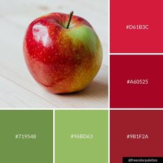 an apple sitting on top of a wooden table next to red and green color swatches