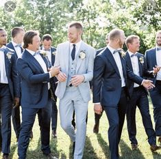 a group of men in suits standing next to each other