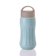 thermos bottle is blue and has a handle on it's side, with a gray lid