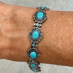 "Sterling silver 7.25\" turquoise bracelet with 9 decorative links and each on set with 1 oval and 1 round blue turquoise stones.  A box and tongue clasp with figure 8 safety weighing 26.12 grams.  14mm in width.  A pretty and well made bracelet." Formal Oval Turquoise Bracelet, Southwestern Blue Oval Bracelets, Bohemian Blue Oval Bracelet, Material Bracelets, Figure 8, Turquoise Stones, Blue Turquoise, Chain Link Bracelet, Turquoise Stone