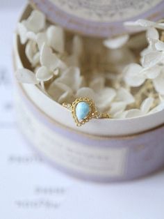 a close up of a ring in a box