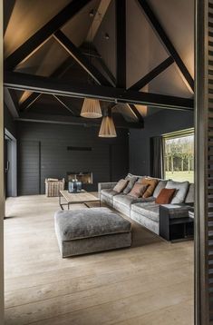 a living room filled with furniture and a fire place next to a wooden flooring wall