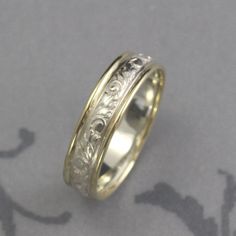 Band Antique Look Ring Gold and Silver Band Two Tone Ring Comfort Fit Band Patterned Ring Vintage Style Band Men's Wedding Ring Women's Band With just a touch of gold added to each side, our two tone Going Baroque band is a lovely compliment to a garden style wedding. Hand made from preformed sterling silver pattern wire featuring a stylized vine and leaf pattern, a 1mm diameter strip of full round solid 14K gold is added to each edge. This gives the band a nice comfort fit edge and also contras Two Tone Ring, Ringe Gold, Pattern Ring, Men's Wedding Ring, Ring Vintage, Ring Gold, Wedding Rings For Women, Silver Band, Vintage Stil