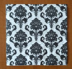 black and white damask paper napkins on wooden table