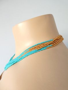 "This stunning turquoise and gold necklace is perfect for that summer dress! This necklace has 8 strands and size shown in pictures is 16\". You can find some matching earrings here: https://www.etsy.com/shop/StephanieMartinCo/search?search_query=turquoise+earringℴ=date_desc&view_type=gallery&ref=shop_search ❤ SIZES This item comes in several sizes, kindly choose at checkout. The easiest way to find out which length suits you best is to measure a necklace you already own, from one end to Gold Beaded Turquoise Necklace For Beach, Gold Turquoise Necklace With Round Beads For Beach, Turquoise Multi-strand Beaded Necklaces With Tiny Beads, Handmade Multi-strand Turquoise Beach Necklace, Turquoise Multi-strand Tiny Beads Necklace, Handmade Multi-strand Turquoise Necklace For Beach, Turquoise Multi-strand Beaded Necklaces, Handmade Multi-strand Turquoise Beads, Handmade Turquoise Multi-strand Beads