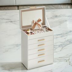 an open jewelry box sitting on top of a table