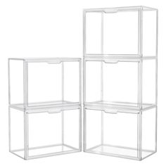 three clear shelving units with drawers on the top and bottom, one is empty