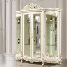 an ornate white china cabinet with glass doors