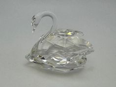 a crystal swan ornament sitting on top of a table