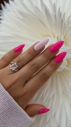 a woman's hand with pink nail polish and a ring on top of her finger