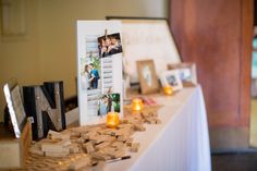 a table topped with pictures and candles on top of it