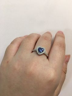 This is a 925. Genuine Sterling Silver and Cubic Zirconia Heart Tanzanite Ring We have sizes: 5, 6, 7, 8, 9 available. Return policy is within 30 days of purchase. Heart Cut Cubic Zirconia Halo Ring, Cubic Zirconia Heart Cut Halo Ring For Promise, Valentine's Day Halo Cubic Zirconia Jewelry, Valentine's Day Cubic Zirconia Halo Jewelry, Heart Cut Promise Ring With Halo Design, Anniversary Heart Cut Ring With Halo Design, Heart Cut Halo Heart Ring For Anniversary, Heart Cut Halo Anniversary Ring, Heart Cut Halo Promise Ring