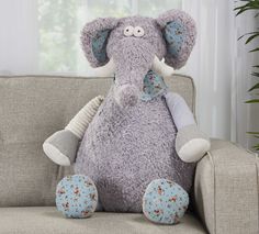 an elephant stuffed animal sitting on top of a couch