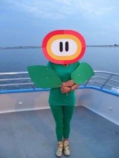 a woman standing on a boat wearing a paper mario costume