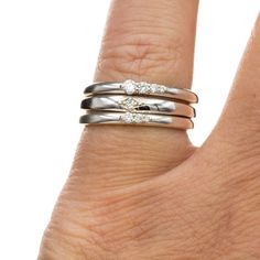 The Gabrielle band is an accented stacking ring with four lab-grown diamonds in gradient sizes. The sweet anniversary stacker features a row of dazzling diamonds on a narrow rounded gold, platinum or silver band. It is the perfect piece of fine jewelry to add sophisticated elegance and timeless luxury to any ring ensemble. Elevate your style with this exclusive and luxurious piece. The narrow domed ring shank is 2mm wide. Height above the finger is 2..6mm. DIAMOND SPEC: Weight: ~0.1 CTW Sizes: 2 Anniversary Polished Finish Stackable Rings, Silver Diamond Stackable Rings With Polished Finish, Partner Rings, Diamond Stacks, Sterling Silver Stacking Rings, Wedding Anniversary Rings, Silver Stacking Rings, Domed Ring, Sterling Silver Bands