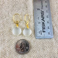 "These gorgeous sea glass drop earrings are made from two pieces of .5-inch smooth, white sea glass, adorned with an elegant gold spiral earring hook. Both hooks and connectors are 18k gold-filled and are hypoallergenic. Come visit my Earring Section for sea glass earrings in other colors and styles! https://www.etsy.com/shop/PendantsForACause?section_id=27147426 ---------- PACKAGING ---------- 🎁 Each handmade piece comes in its own beautiful, velvet-lined jewelry box and is ready to give as a Beach Glass Jewelry, Jewelry For Mom, White Sea Glass, Glass Drop Earrings, Beachglass Jewelry, Jewelry Beach, Sea Glass Earrings, White Sea, Spiral Earrings