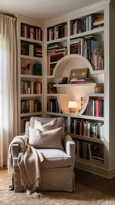 a living room filled with lots of books and furniture next to a wall mounted book shelf