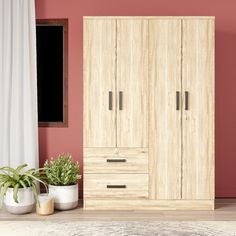 a bedroom with two planters on the floor and a large wooden cabinet next to it