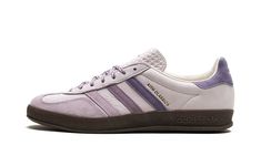 The Kith x adidas Handball Spezial “Classics Program - Ash Purple” is a collaboration by the popular New York-based retailer on the retro shoe.  The adidas Handball Spezial “Classics Program - Ash Purple” is from a larger collection of “Classic Program” styles by Kith and its founder, Ronnie Fieg.  The upper features an Ash Purple leather and suede construction, with gradient purple leather Three Stripes branding.  A “Kith Classics” logo appears on the lateral side of the mid-panel, while “Kith” Purple Adidas, Purple Gazelle, Purple Adidas Shoes, Purple Adidas Sneakers, Adidas Purple Leather Sneakers, Adidas Shoes Gazelle, Dark Gums, Purple Sneakers, Purple Shoes