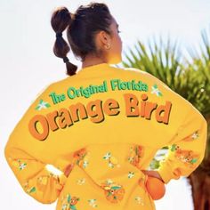 a woman wearing an orange bird jacket