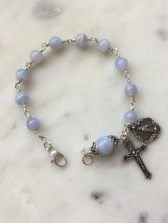 Beautiful handmade 6 and 8mm blue lace agate rosary bracelet. The beads are wire-wrapped with sterling silver, 22 gauge wire and all other metal parts and medals are sterling silver. Cheap Blue Rosary Bracelet As Gift, Blue Agate Jewelry, Blue Lace Agate Jewelry, Blue Lace Agate Bracelet, Blue Rosary, Jewelry Styles, Catholic Jewelry, Rosary Bracelet, Wire Work Jewelry