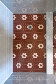 two tiled walls in a bathroom with red and white tiles