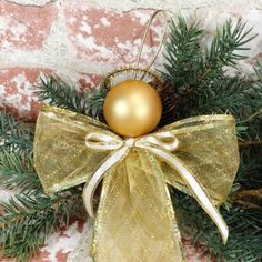 a golden ornament hanging from a christmas tree