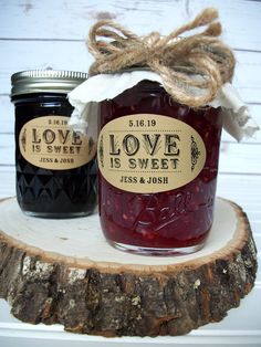 two jars of jam sitting on top of a tree stump