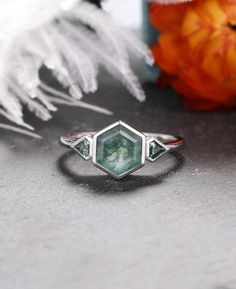 Natural Moss Agate - OCTOBER BIRTHSTONE: UNIFIES COMPASSION - A stunning piece that will enchant you with its magical sparkles. Stone Replacement: Moissanite: https://www.etsy.com/listing/1053803134/bezel-hexagon-engagement-ring-moissanite Natural Sunshine Stone: https://www.etsy.com/listing/1308816902/hexagon-natural-sunshine-stone-ring-kite Natural Moss Agate: https://www.etsy.com/listing/1322815157/hexagon-moss-agate-wedding-ring-three § RING SPECIFICATIONS § ---------------------------------- * Metal Type: Silver 925/ 10/14/18K Yellow Gold, Rose Gold And White Gold (Contact me if you want to customize with other metal)  Note: In material drop down options - 14KW mean 14k white gold, 14KY mean 14k yellow gold, 14KR mean 14k rose gold White Gold Emerald Ring With Bezel Setting As Gift, Emerald Cut Gemstone Accents Ring For Gift, Fine Jewelry Hexagon Bezel Setting, May Birthstone Crystal Ring With Bezel Setting As Gift, Unique Emerald Ring With Bezel Setting For Wedding, Adjustable Green Crystal Wedding Ring, Adjustable Faceted Rings For Wedding, Spiritual Wedding Jewelry With Bezel Setting, Adjustable Green Crystal Ring For Wedding