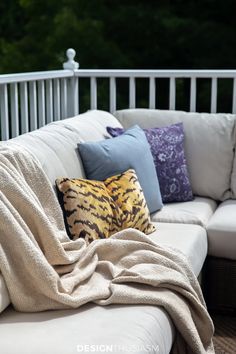 a white couch sitting on top of a wooden floor