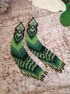 Green Bohemian Beaded Dangle Earrings, Handmade Green Bohemian Tassel Earrings, Elegant Green Beaded Earrings With Tassels, Green Long Drop Jewelry With Dangling Beads, Elegant Green Beaded Fringe Tassel Earrings, Bohemian Green Jewelry With Beaded Fringe, Green Bohemian Long Drop Earrings, Bohemian Green Long Drop Earrings, Elegant Green Beaded Fringe Earrings