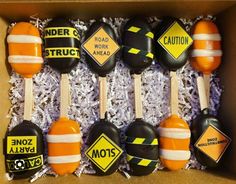 an assortment of road work spoons in a box with caution stickers on them