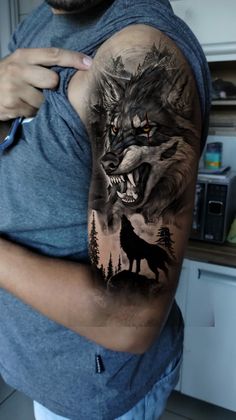 a man with a wolf tattoo on his arm and shoulder is holding the other half of his body