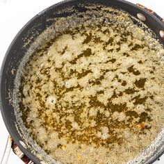 a frying pan filled with lots of food on top of a stove burner