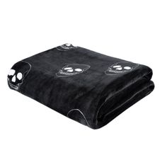 a black blanket with skulls on it and two eyes drawn on the front, in white